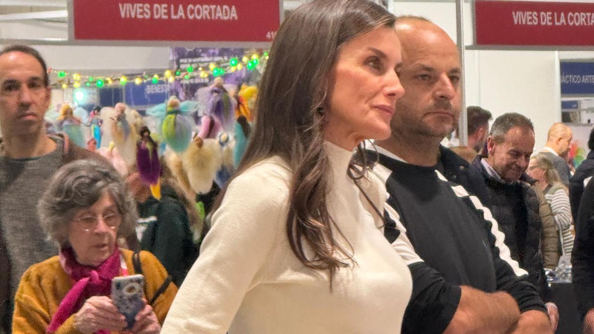 Letizia tvariai apsiperka su juodomis platėjančiomis kelnėmis ir smėlio spalvos megztiniu